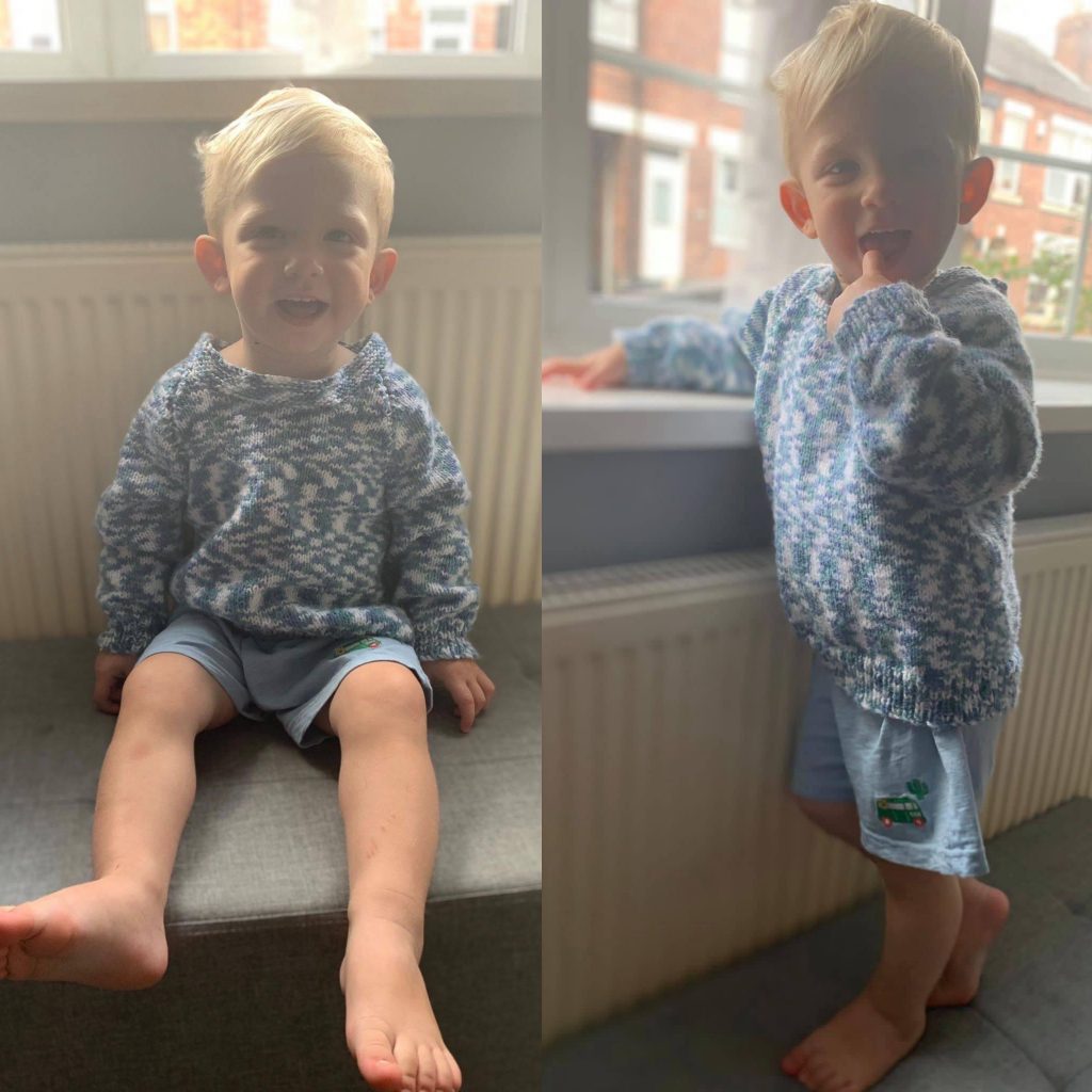 A member of our team's son wearing a jumper that was made by one of our clients
